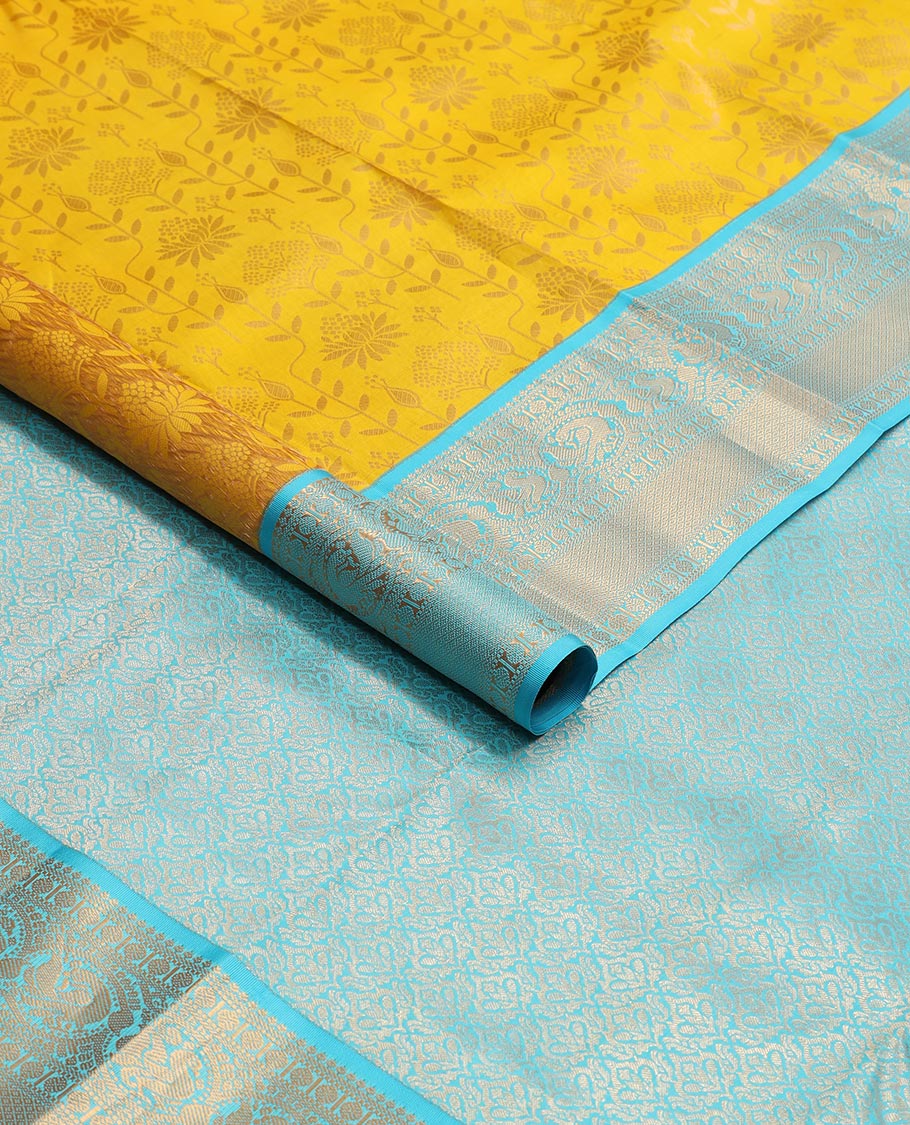 Yellow floral design kancheepuram silk saree with contrast border of thilakam mokku, banaras, muthu, paun design & zari design pallu