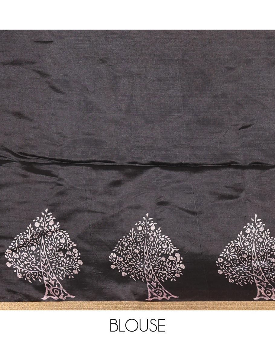 Black tree motifs discharge printed banana pith saree, zari piping border, floral printed pallu, and a tree discharge printed blouse