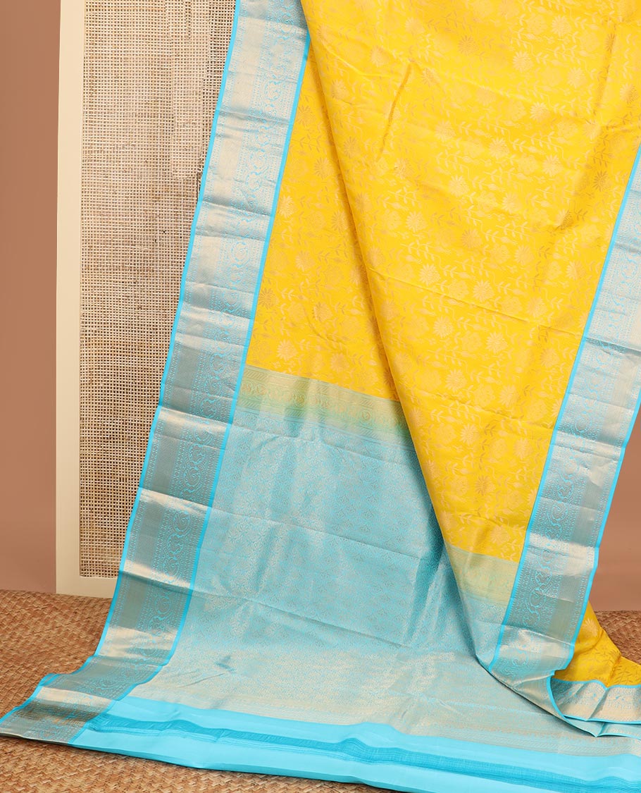 Yellow floral design kancheepuram silk saree with contrast border of thilakam mokku, banaras, muthu, paun design & zari design pallu