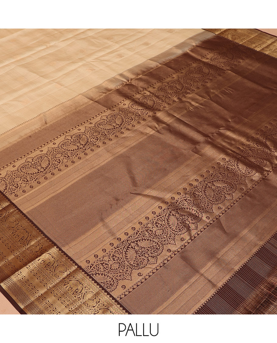 Sandal Vasundhara Silk Saree, Sparsely Sparkled with Zari Checks and Mayil Buttas, a Contrast Border of Thilakam Mokku, Banaras, Neli, Mayil, Yaanai, Mayil Kann, and Ara Maadam Designs, Grand Pallu, and a Contrast Blouse