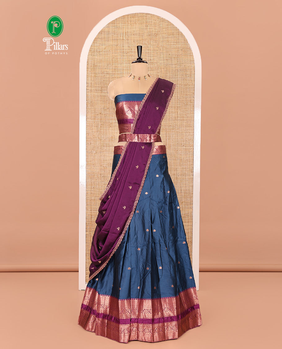 Blue and Purple Semi-Banarasi Half-Saree Featuring Zari Buttas Skirt, Complemented by Contrast Rettai Pettu, Traditional Border of Floral Creeper Designs, Paired with a Matching Blouse, and a Satin Georgette Embroidered Scallop Dhavani