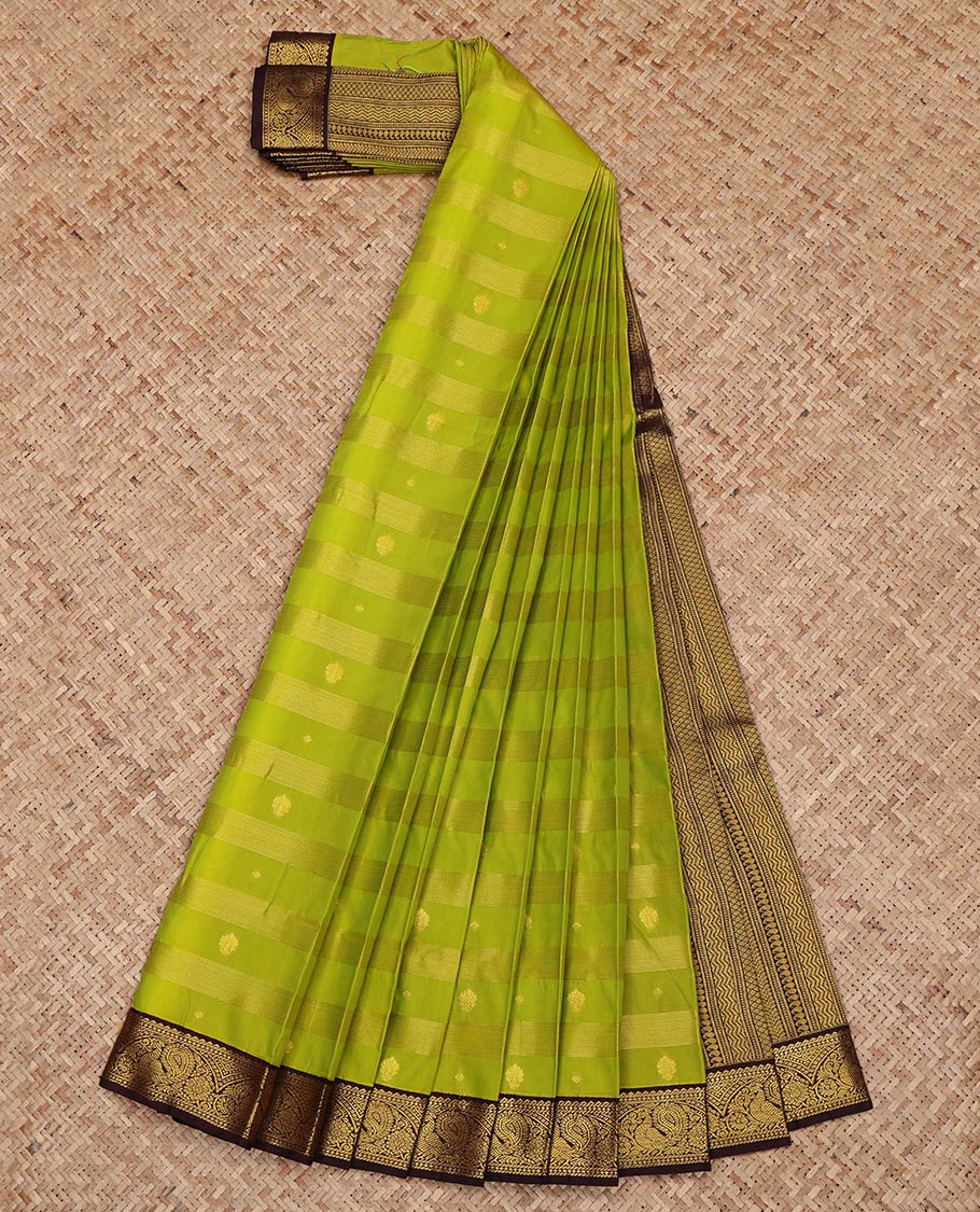 Leaf Green Budget Silk Saree, Gleamed Up with Zari Buttas and Zari Stripes on Its Body, Complemented by a Contrast Traditional Zari Border of Peacock Designs, Grand Pallu, and Paired with a Contrast Blouse
