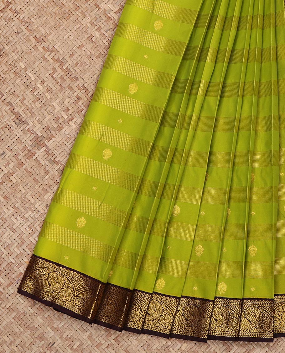 Leaf Green Budget Silk Saree, Gleamed Up with Zari Buttas and Zari Stripes on Its Body, Complemented by a Contrast Traditional Zari Border of Peacock Designs, Grand Pallu, and Paired with a Contrast Blouse