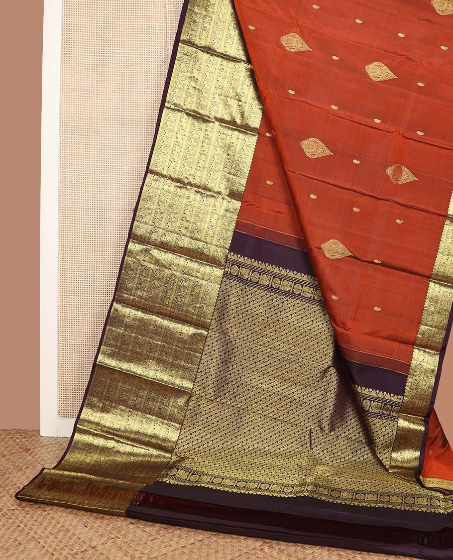 Orange manga buttas Kanchipuram silk saree, contrast border of thilakam mokku, kathir, kuthirai, and yaanai designs, and pallu steeped with manga motifs