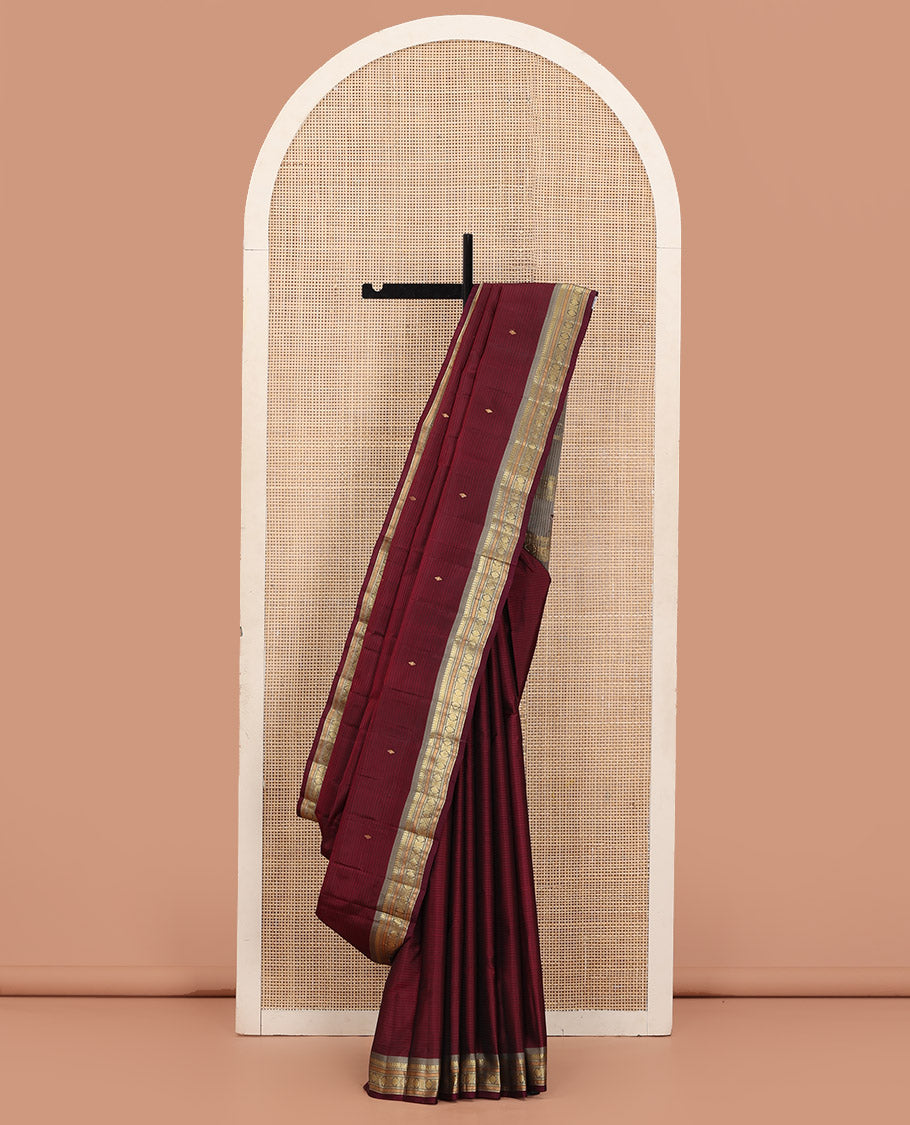 Maroon Kanchipuram Silk Saree Beautified with Vazhaipoo Stripes and Zari Buttas, Complemented by Contrast Border Featuring Manga Mokku, Muthu, Greek Key, and Laddu Kamalam Designs, Sparsely Zari Woven Pallu, and Paired with a Contrast Blouse