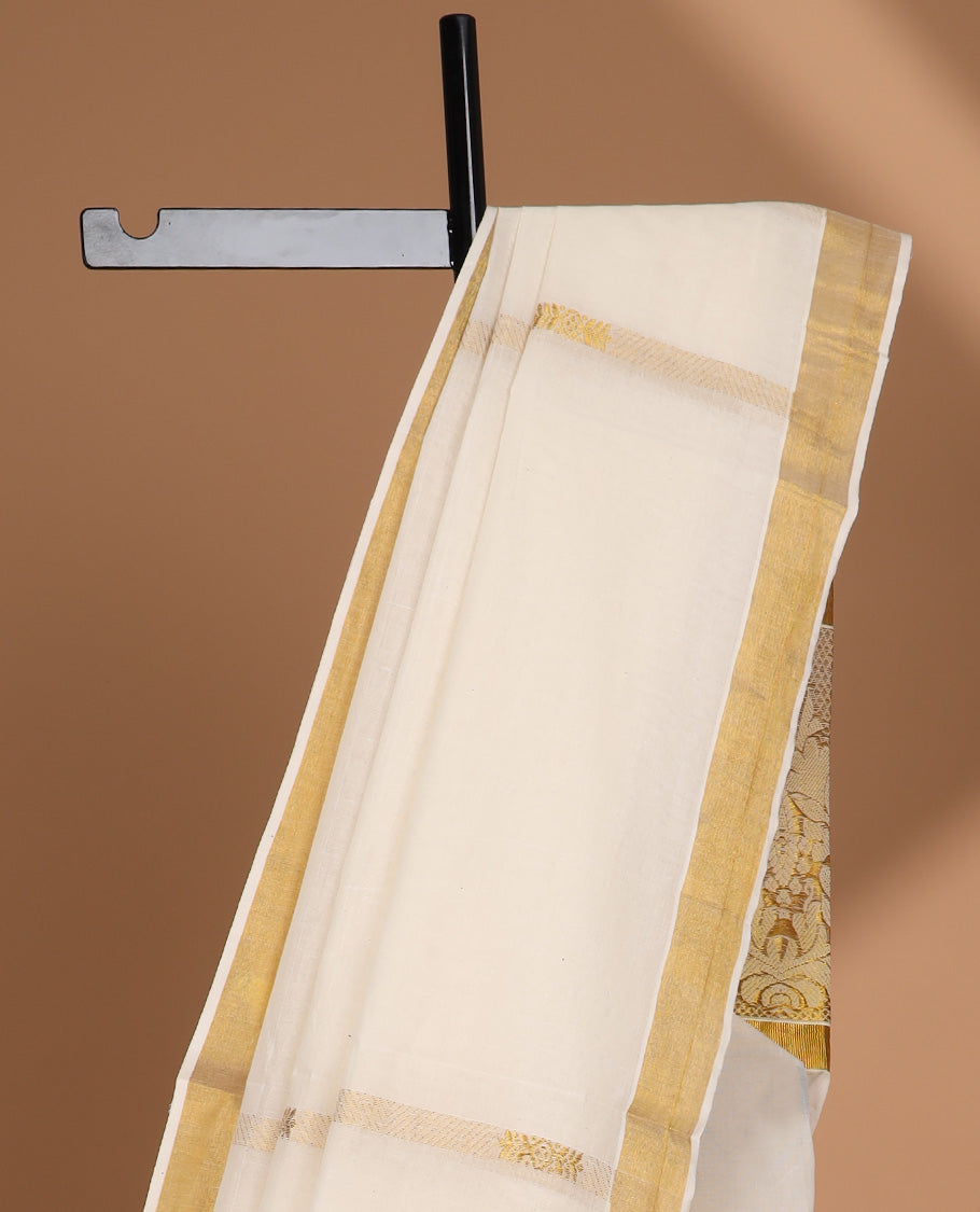 Cream kerala saree with zari designs, zari border & pallu of intricate designs