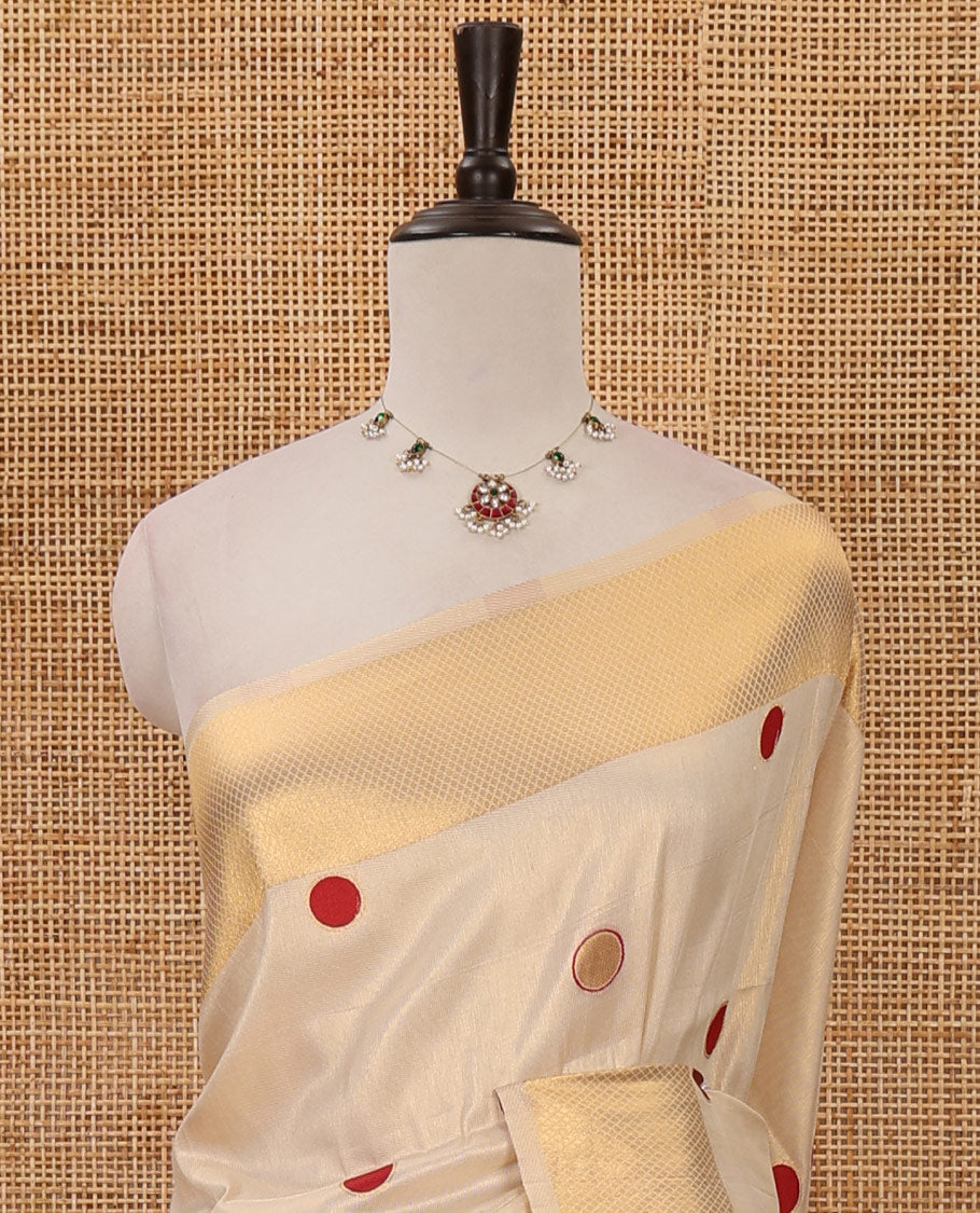 Cream small red polka dots banarasi tissue saree, zari border, pallu of red polka dots & running plain blouse