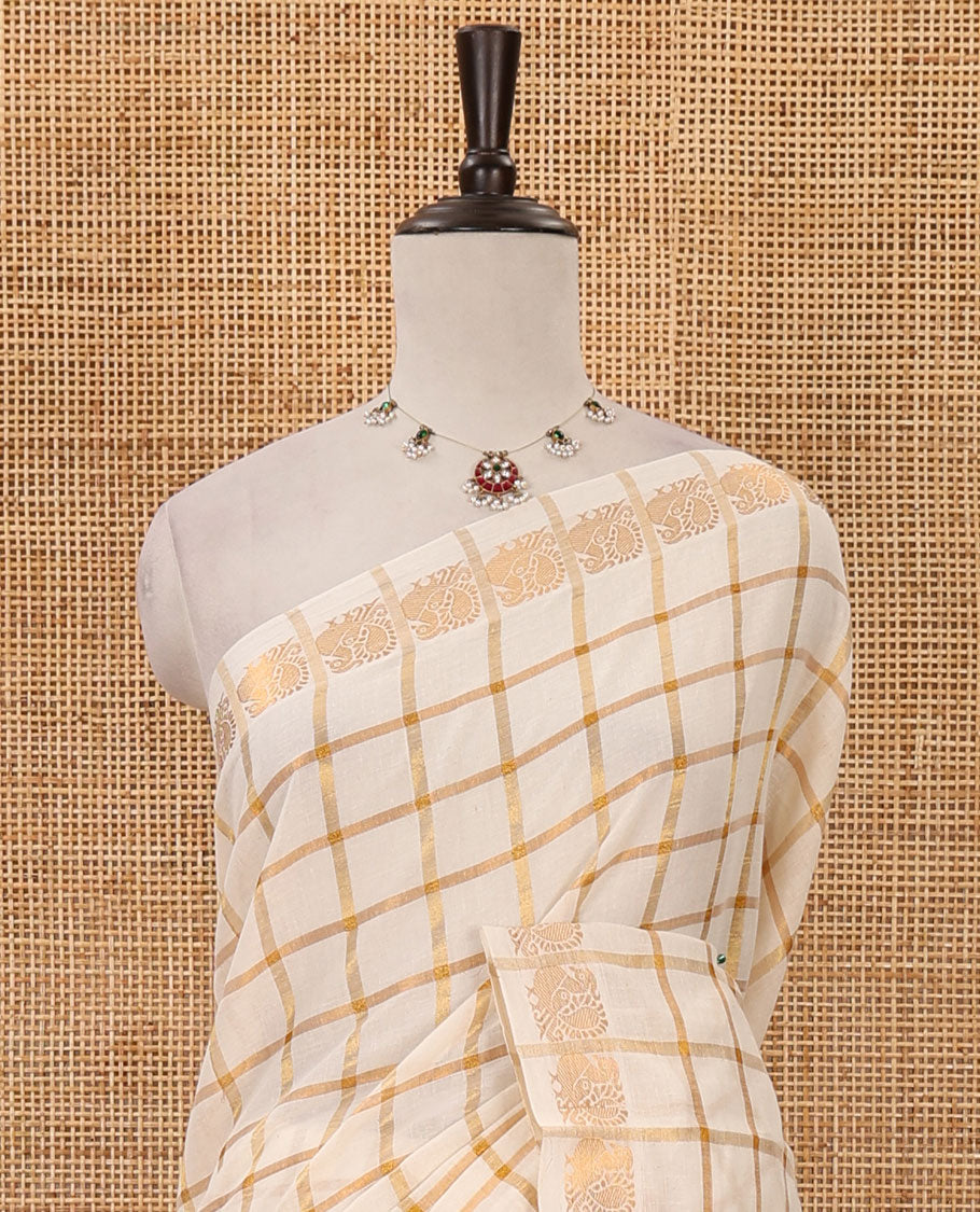 Cream golden zari checked sungudi cotton saree, zari border of peacock motifs & contrast red checked peacock motif blouse