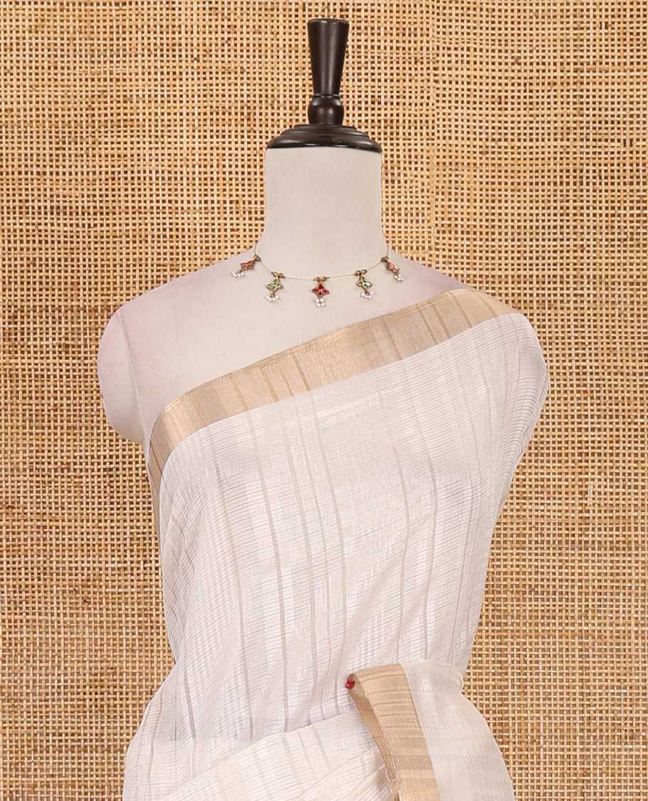 Cream striped tissue saree, gold zari piping border, zari striped pallu & plain blouse