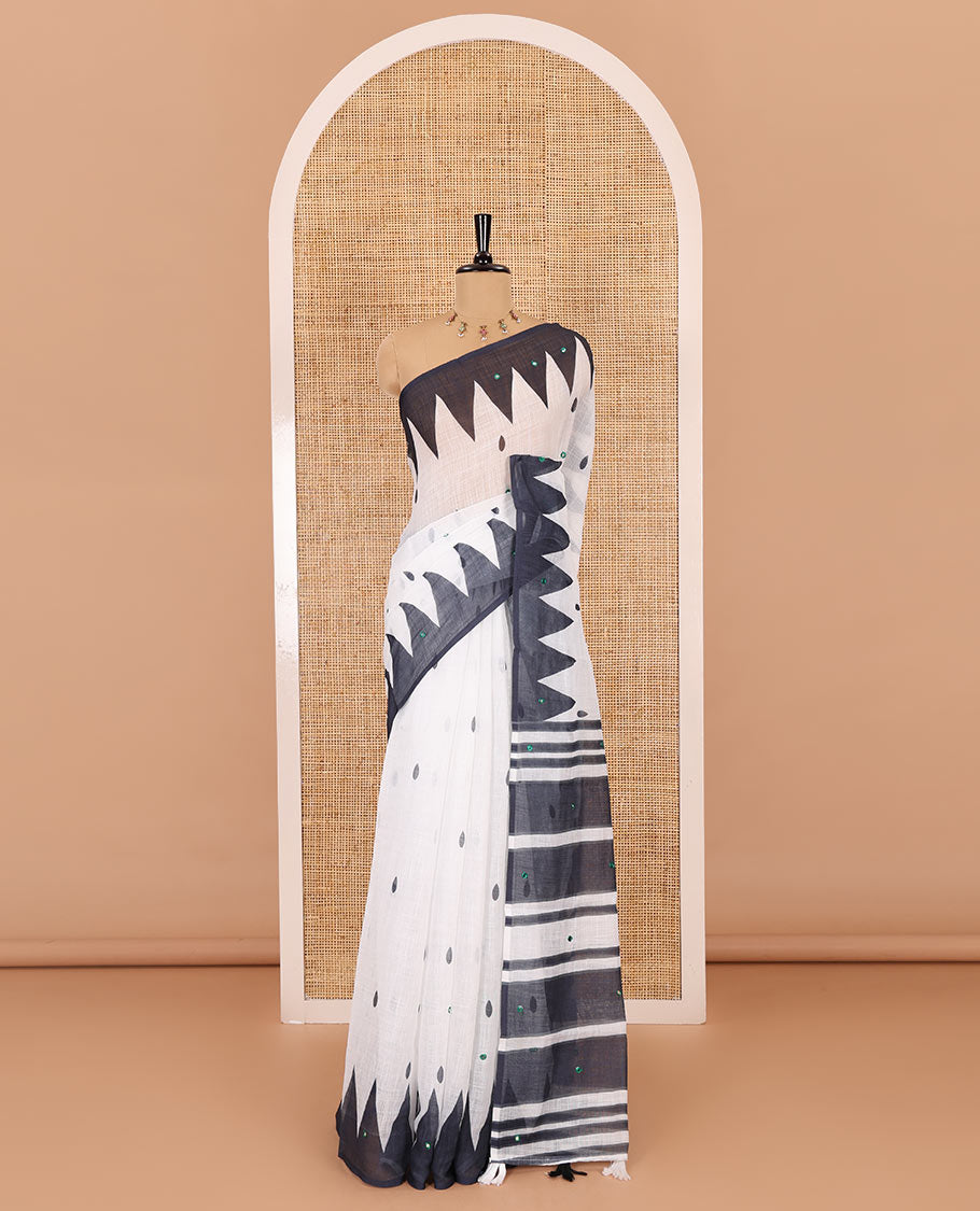 White thilakam buttas and mirror work khadi mul cotton saree, contrast temple border, striped and buttas pallu, and a contrast printed blouse