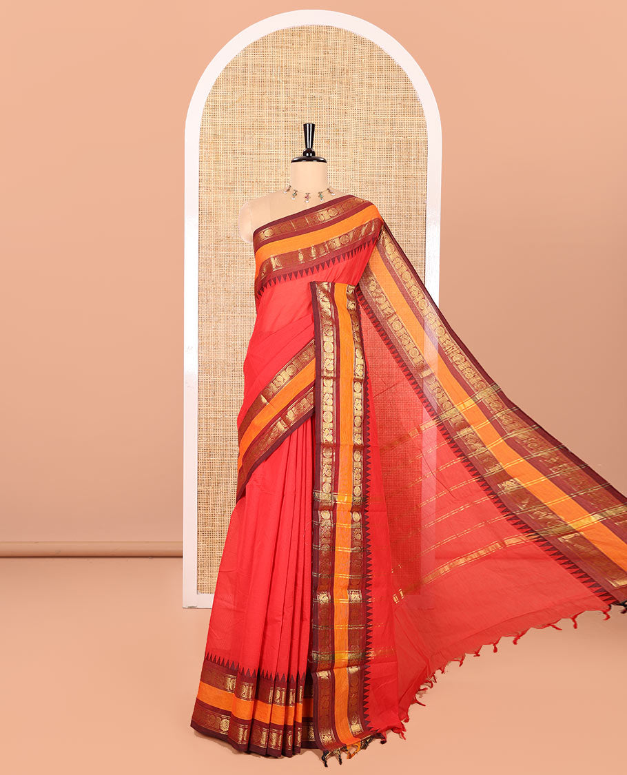 Red Plain Chettinad Cotton Saree, Complemented by Contrast Rettai Pettu Temple Border of Peacock Chakram Designs, Gleaming Striped Pallu, and Paired with a Matching Blouse
