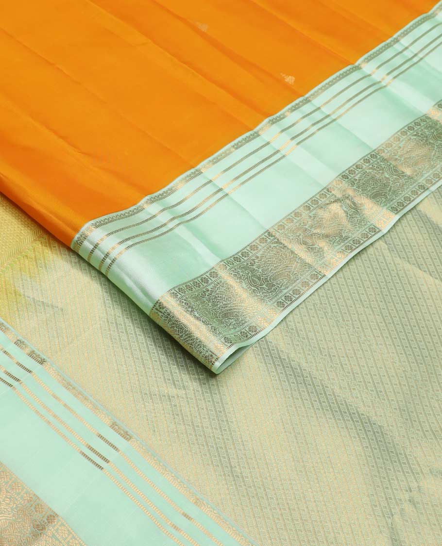 Orange zari buttas Vasundhara silk mix saree, contrast rettai pettu border of muthu, kamalam and annam designs, and intricate pallu