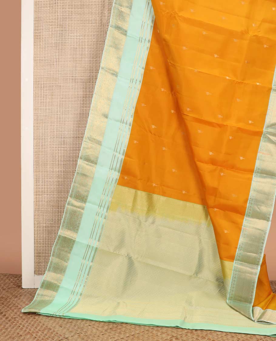 Orange zari buttas Vasundhara silk mix saree, contrast rettai pettu border of muthu, kamalam and annam designs, and intricate pallu