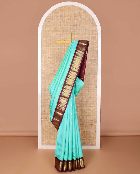 Sea blue buttas kancheepuram silk saree with contrast korvai border of thilakam mokku, banaras, geometric design & floral design pallu