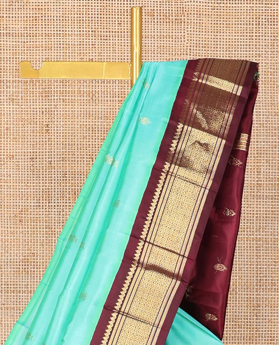 Sea blue buttas kancheepuram silk saree with contrast korvai border of thilakam mokku, banaras, geometric design & floral design pallu