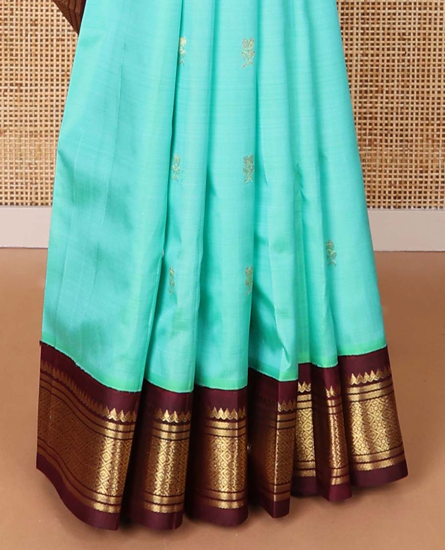 Sea blue buttas kancheepuram silk saree with contrast korvai border of thilakam mokku, banaras, geometric design & floral design pallu