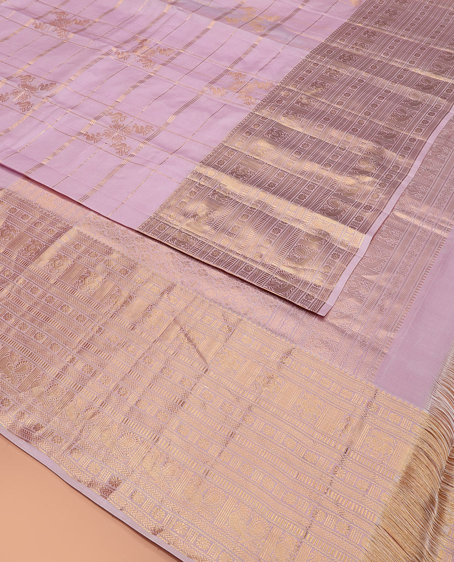 Pink Vasundhara Silk Saree Elevated with Zari Designs All Over Its Body, Complemented by Zari Border of Rekku, Kathir, Star Vanki, Iruthalai Pakshi, and Mayil Designs, a Grand Pallu, and Paired with a Matching Blouse