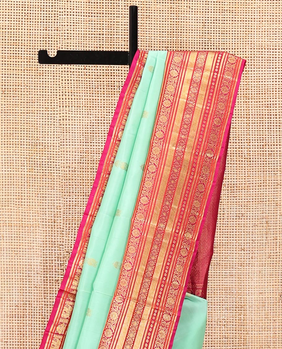 Turquoise Vasundhara Silk Saree, Embellished with Zari Buttas All Over Its Body, Complemented by a Contrast Border of Thilakam Mokku, Yaanai, Iruthalai Pakshi, and Kodi Visiry Designs, Grand Pallu, and Paired with a Contrast Blouse