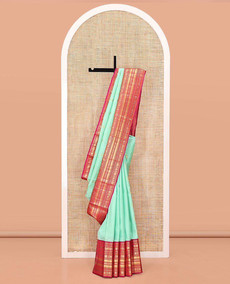 Turquoise Vasundhara Silk Saree, Embellished with Zari Buttas All Over Its Body, Complemented by a Contrast Border of Thilakam Mokku, Yaanai, Iruthalai Pakshi, and Kodi Visiry Designs, Grand Pallu, and Paired with a Contrast Blouse