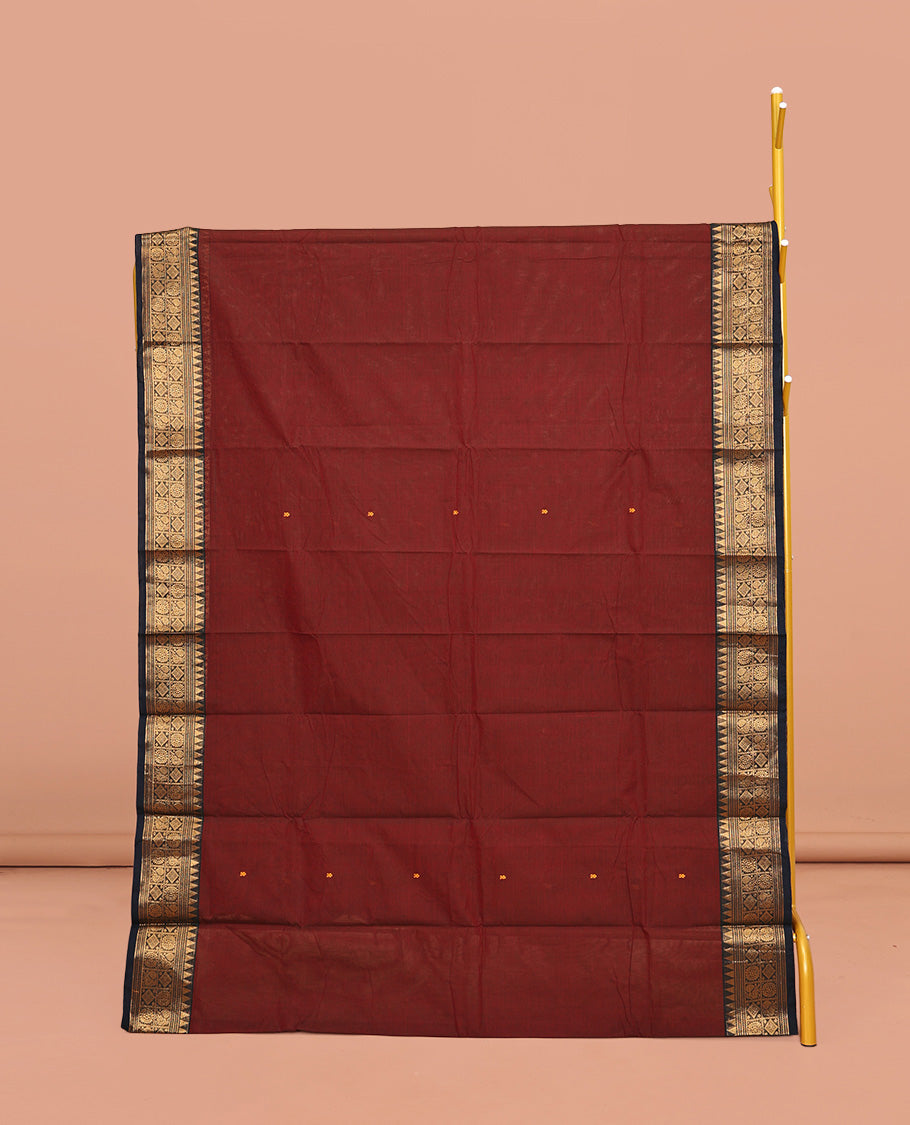 Maroon Chettinad Cotton Saree, Woven with Buttas All Over Its Body, Complemented by a Contrast Traditional Zari Design Woven Border, Pallu of Stripes, and Buttas, and Paired with a Matching Blouse