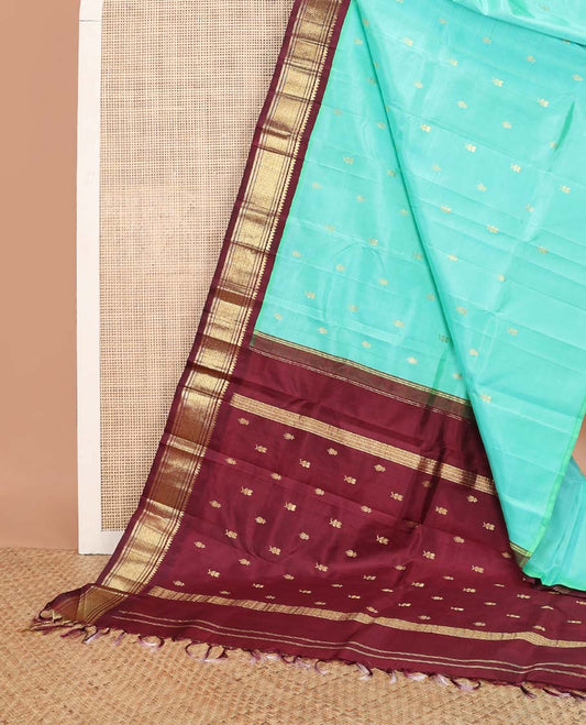 Sea blue buttas kancheepuram silk saree with contrast korvai border of thilakam mokku, banaras, geometric design & floral design pallu