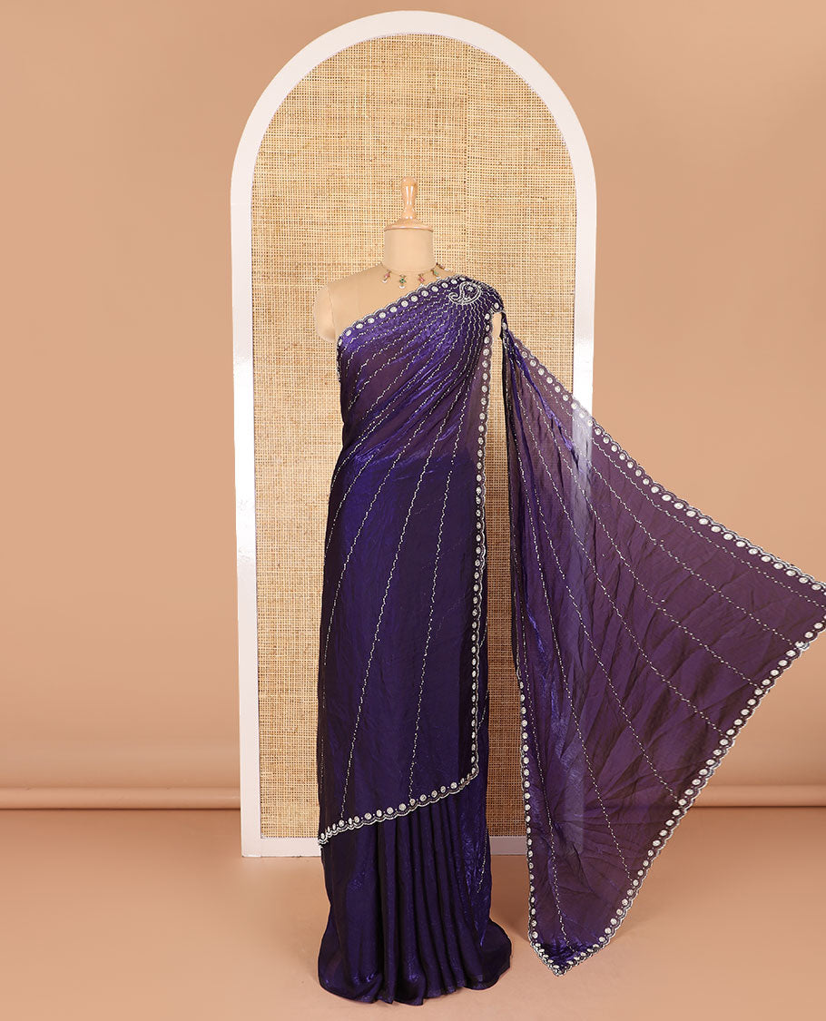 Violet micro-stone work fendy chiffon saree with paisley stone work on its shoulder, a scallop stone work border, a butterfly style pallu, and a matching stone work blouse