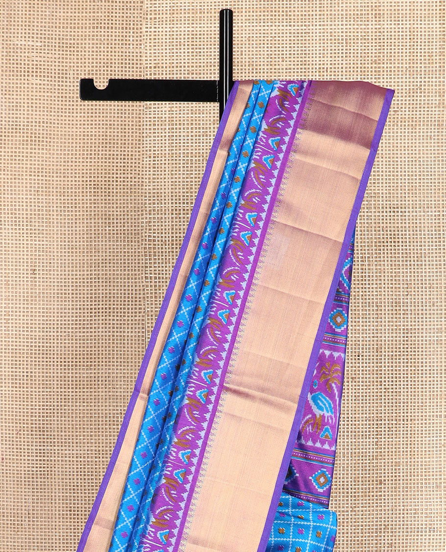 Blue buttas enclosed jaal patola silk saree, contrast temple zari border of swan motifs, and pallu of swan and diamond motifs