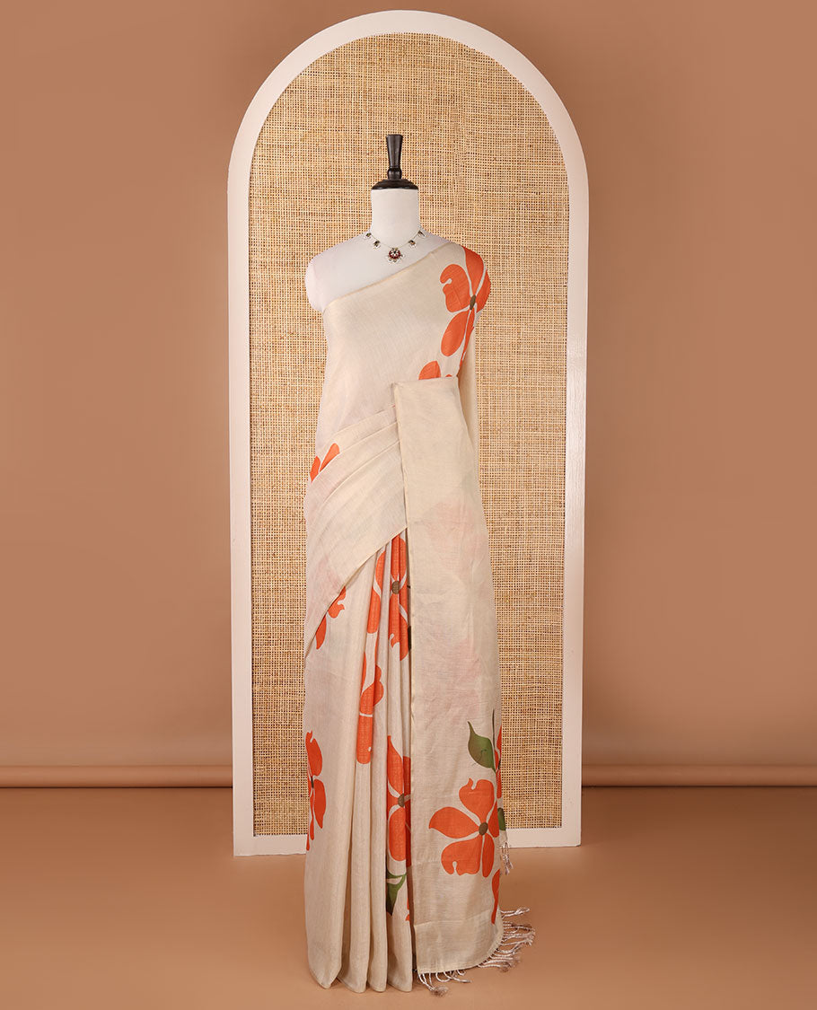 Borderless cream printed onam tissue silk saree features orange color five-petal flower & leaf motifs print, matching floral print blouse
