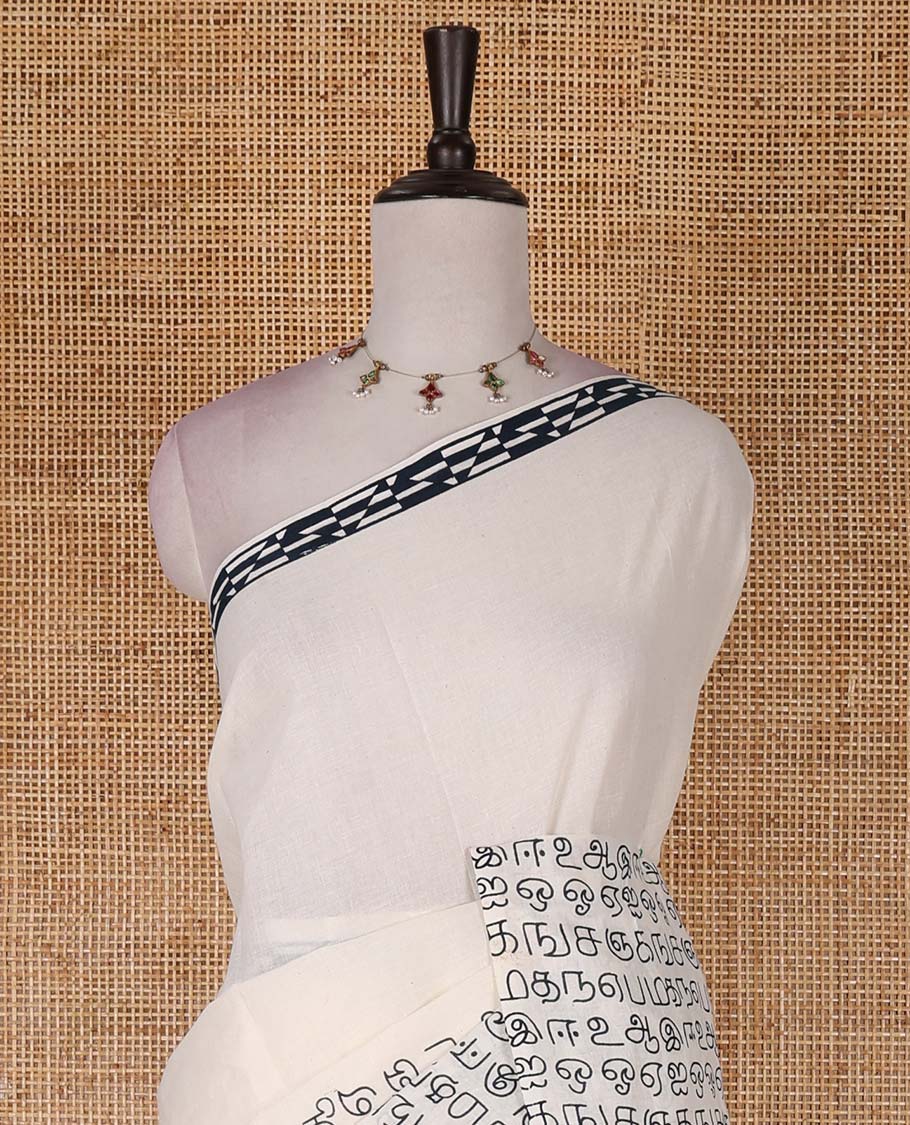 Borderless white Tamil letters printed Sungudi cotton saree with contrast Tamil letters printed blouse