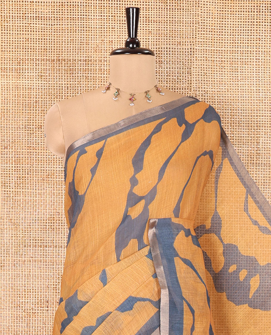 Mustard Linen Cotton Saree, Adorned with Shibori Prints on Its Body, Subtle Contrast Piping Border, Pallu of Floral Print, and Paired with a Matching Blouse