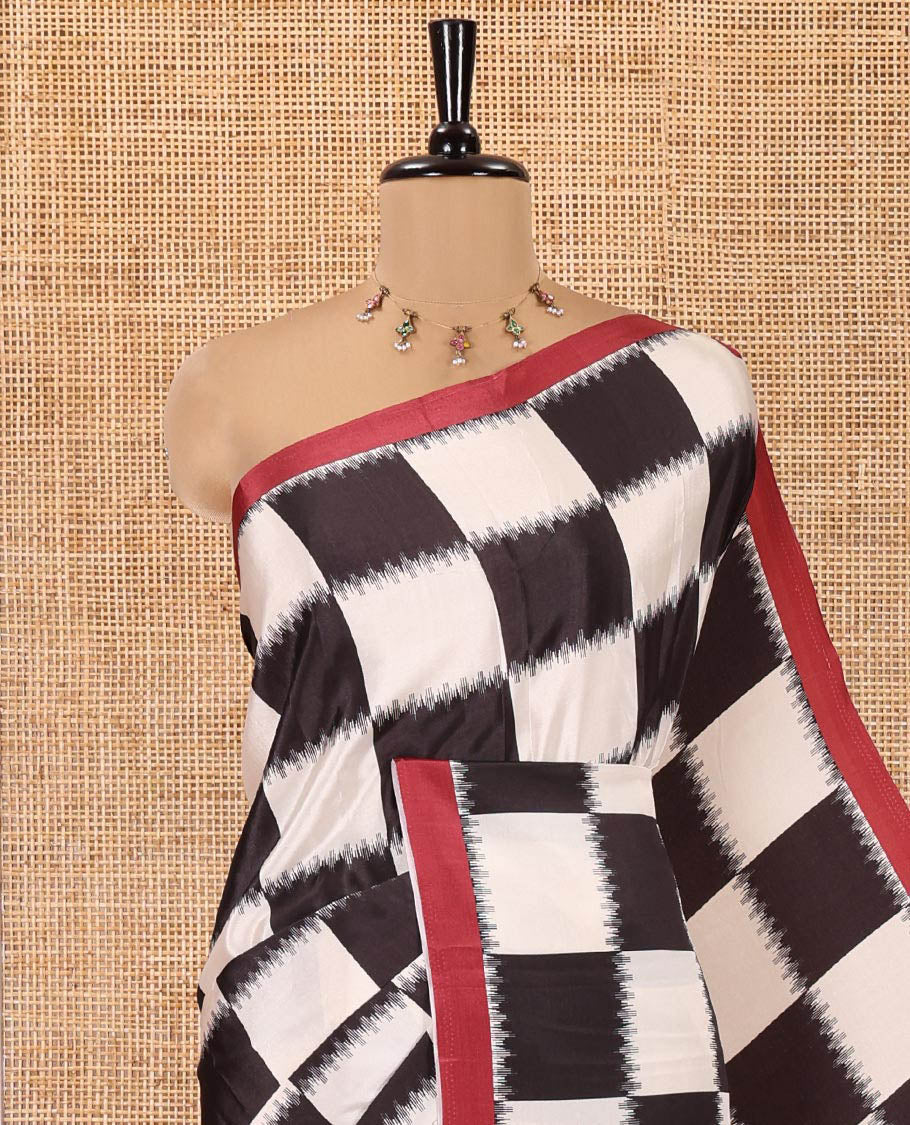 Cream and Black Satin Crepe Saree, Highlighted with Chess-Style Checked Design in Ikkat Weave, Complemented by a Contrast Border, Ikkat Chevron Printed Pallu, and Paired with a Contrast Blouse