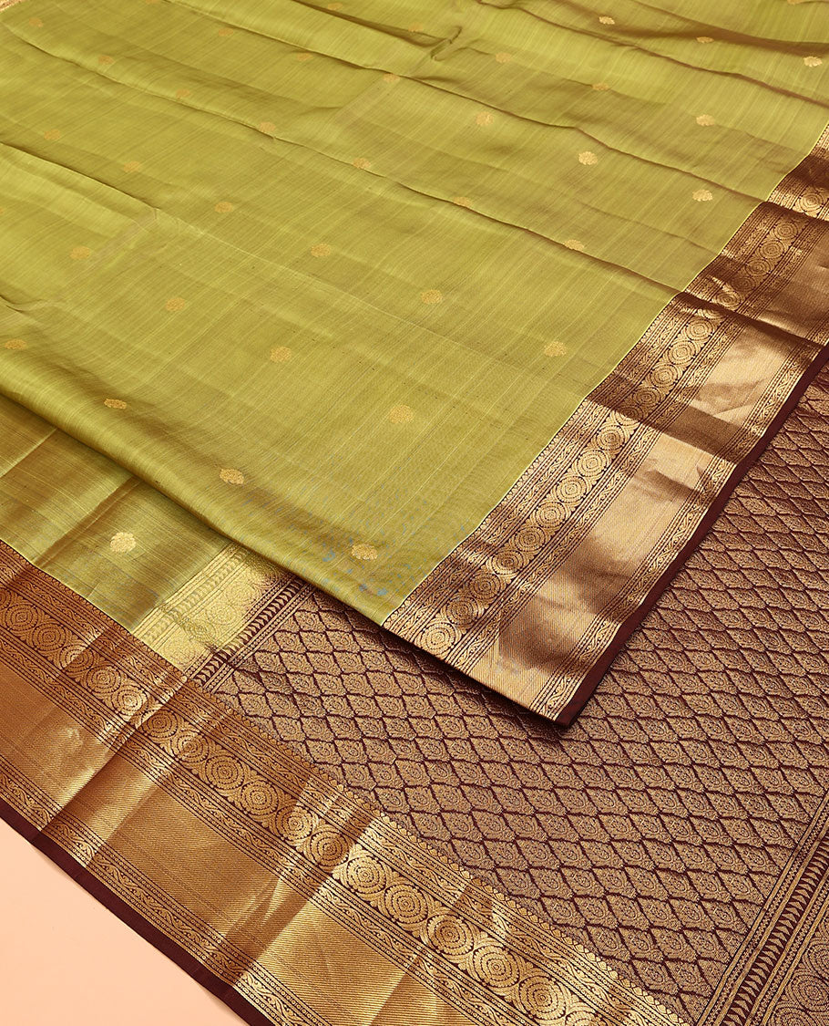Green Vasundhara Lite Silk Mix Saree, Subtly Woven with Zari Buttas on Its Body, Complemented by a Contrast Border of Kodi Visiry and Chakram Designs, Pallu of Jaal Designs, and Paired with a Contrast Blouse