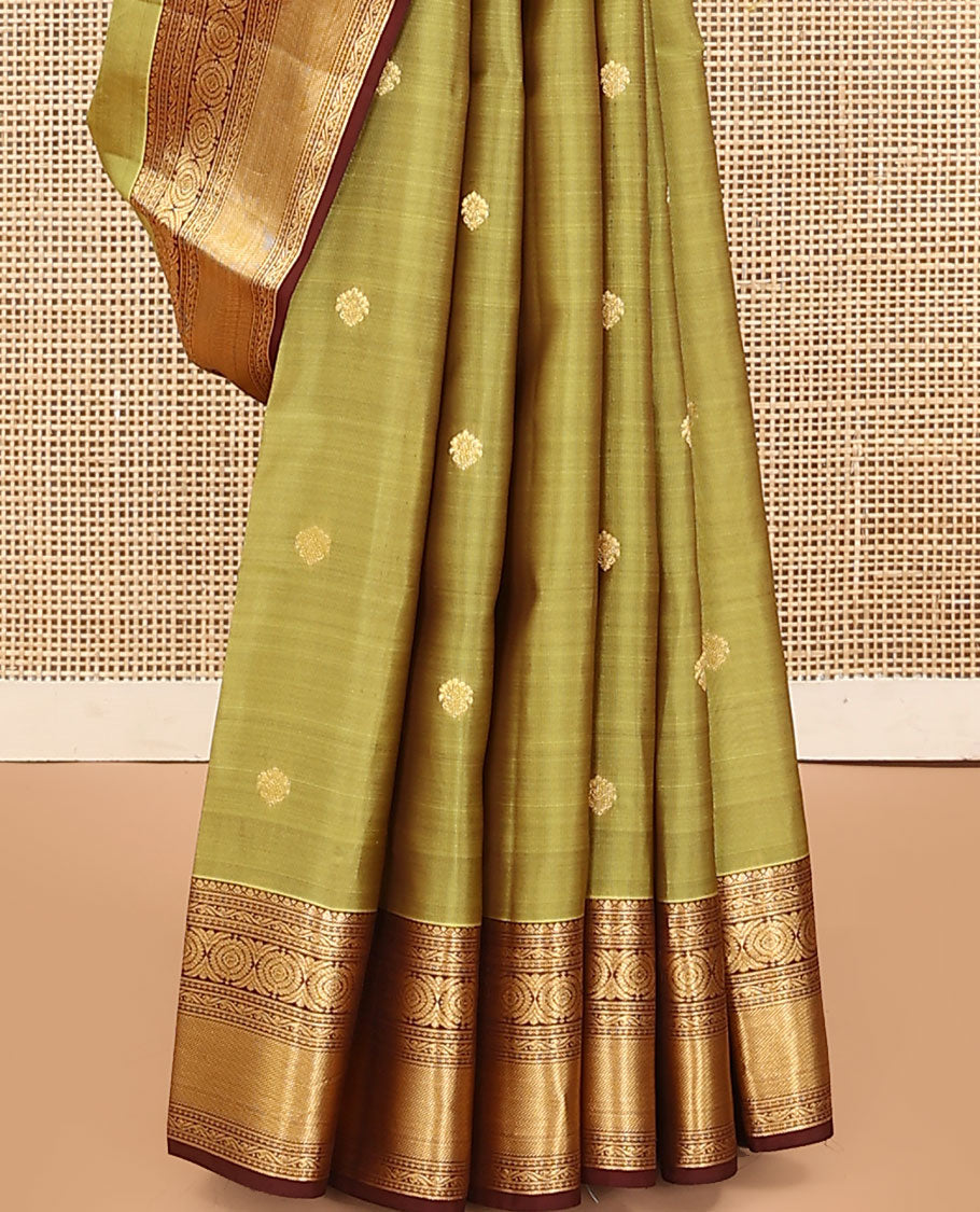 Green Vasundhara Lite Silk Mix Saree, Subtly Woven with Zari Buttas on Its Body, Complemented by a Contrast Border of Kodi Visiry and Chakram Designs, Pallu of Jaal Designs, and Paired with a Contrast Blouse