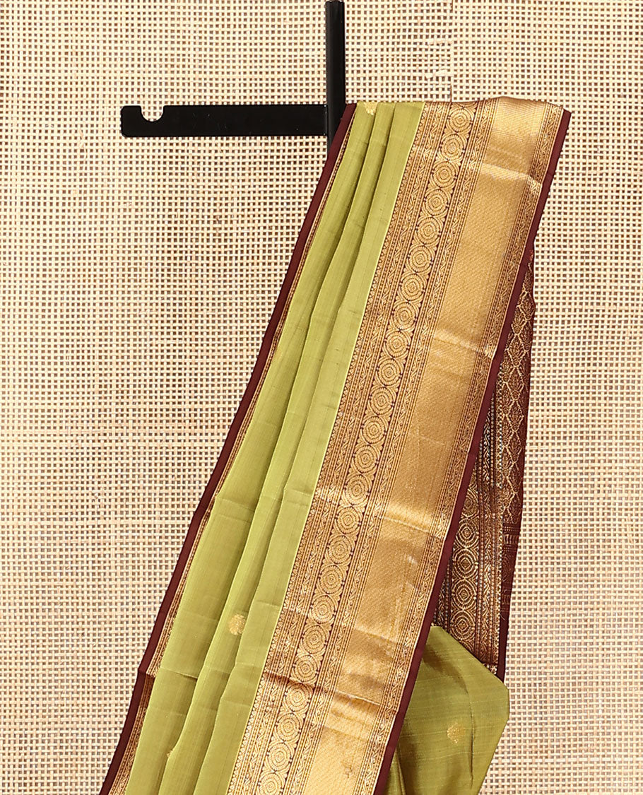 Green Vasundhara Lite Silk Mix Saree, Subtly Woven with Zari Buttas on Its Body, Complemented by a Contrast Border of Kodi Visiry and Chakram Designs, Pallu of Jaal Designs, and Paired with a Contrast Blouse