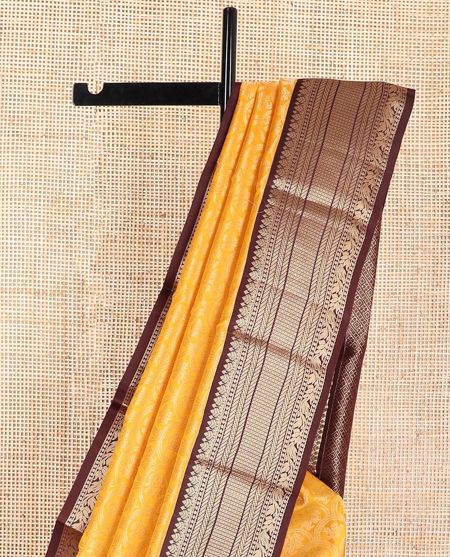 Orange floral jaal design kancheepuram silk saree with contrast border of thilakam mokku, banaras, muthu design & zari design pallu