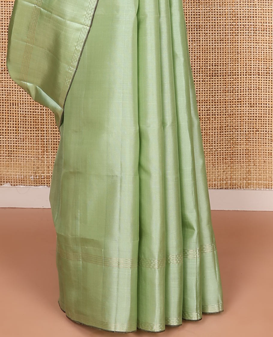 Green yaanai buttas soft silk saree, zari striped border, and contrast yaanai and house motifs woven pallu