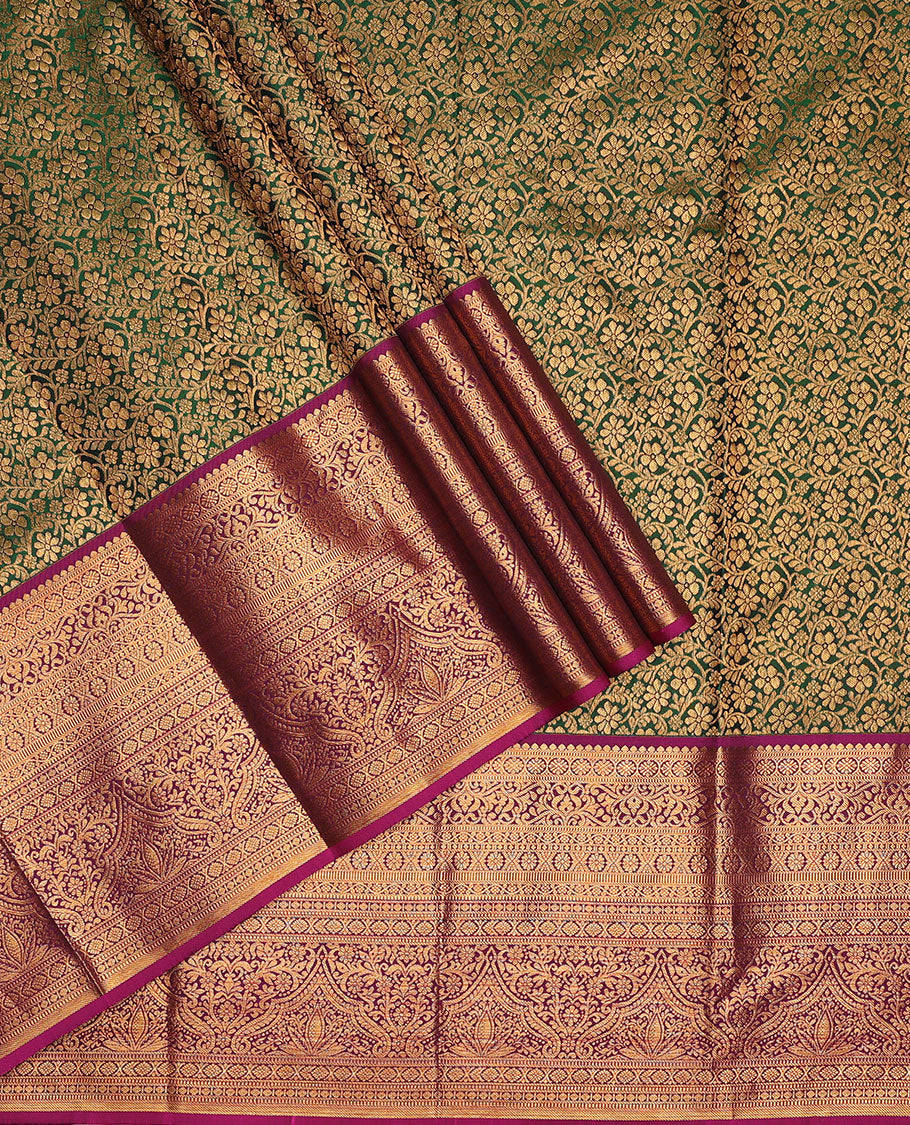 Green pure-silk half-saree, floral jacquard skirt, contrast blouse, and border of salangai, muthu, kamalam, kodi visiry and traditional designs, and intricate dhavani