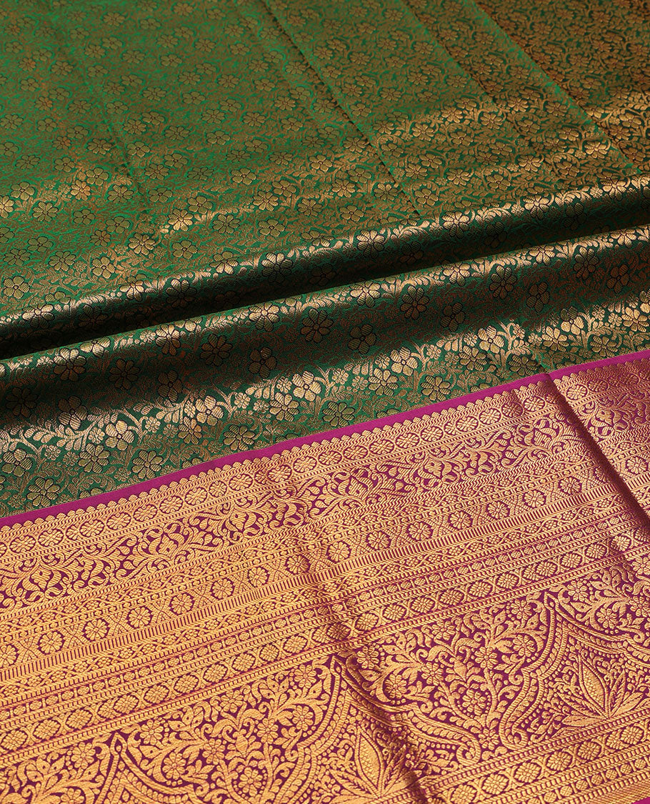 Green pure-silk half-saree, floral jacquard skirt, contrast blouse, and border of salangai, muthu, kamalam, kodi visiry and traditional designs, and intricate dhavani