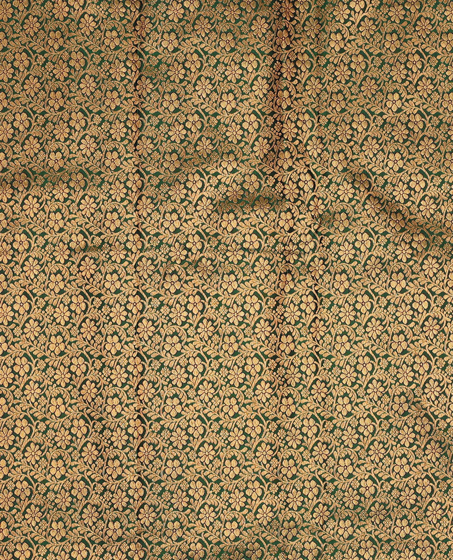 Green pure-silk half-saree, floral jacquard skirt, contrast blouse, and border of salangai, muthu, kamalam, kodi visiry and traditional designs, and intricate dhavani