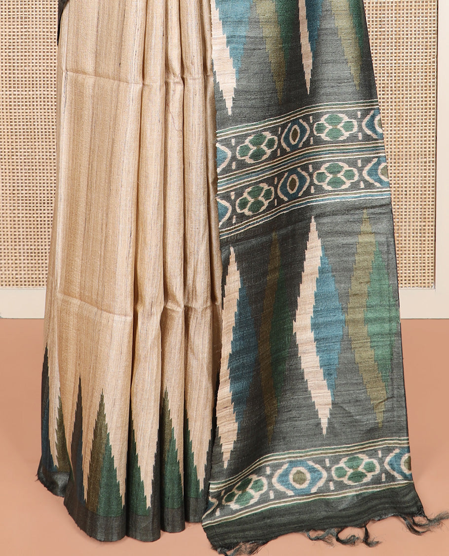 Light sandal plain tussar saree, contrast temple border, and geometric patterned pallu