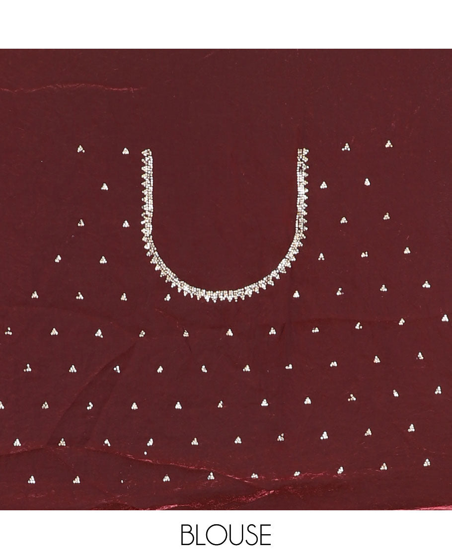 Maroon micro-stone work fendy chiffon saree with paisley stone work on its shoulder, a scallop stone work border, a butterfly style pallu, and a matching stone work blouse