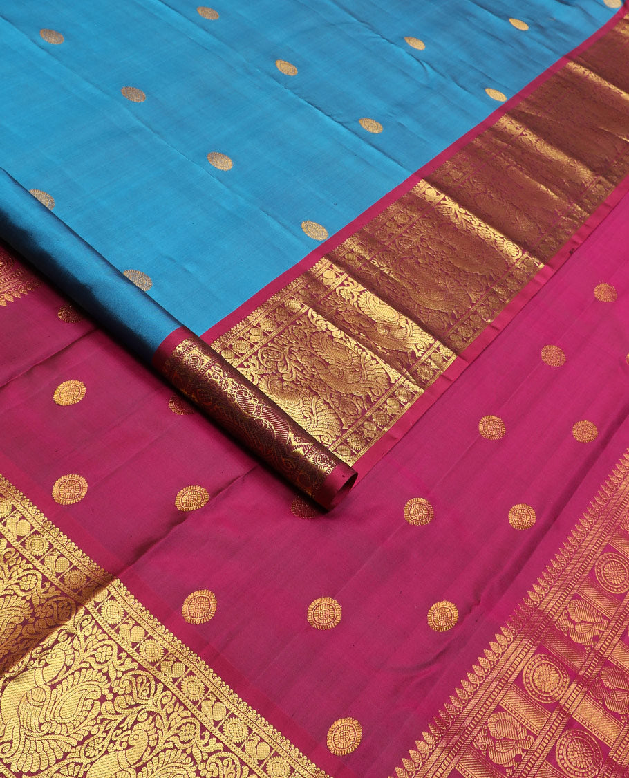 Blue chakram buttas Kanchipuram silk saree, contrast border of mayil chakram designs, and pallu steeped with chakram motifs