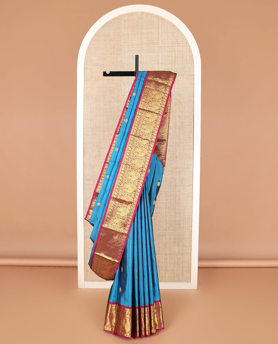 Blue chakram buttas Kanchipuram silk saree, contrast border of mayil chakram designs, and pallu steeped with chakram motifs