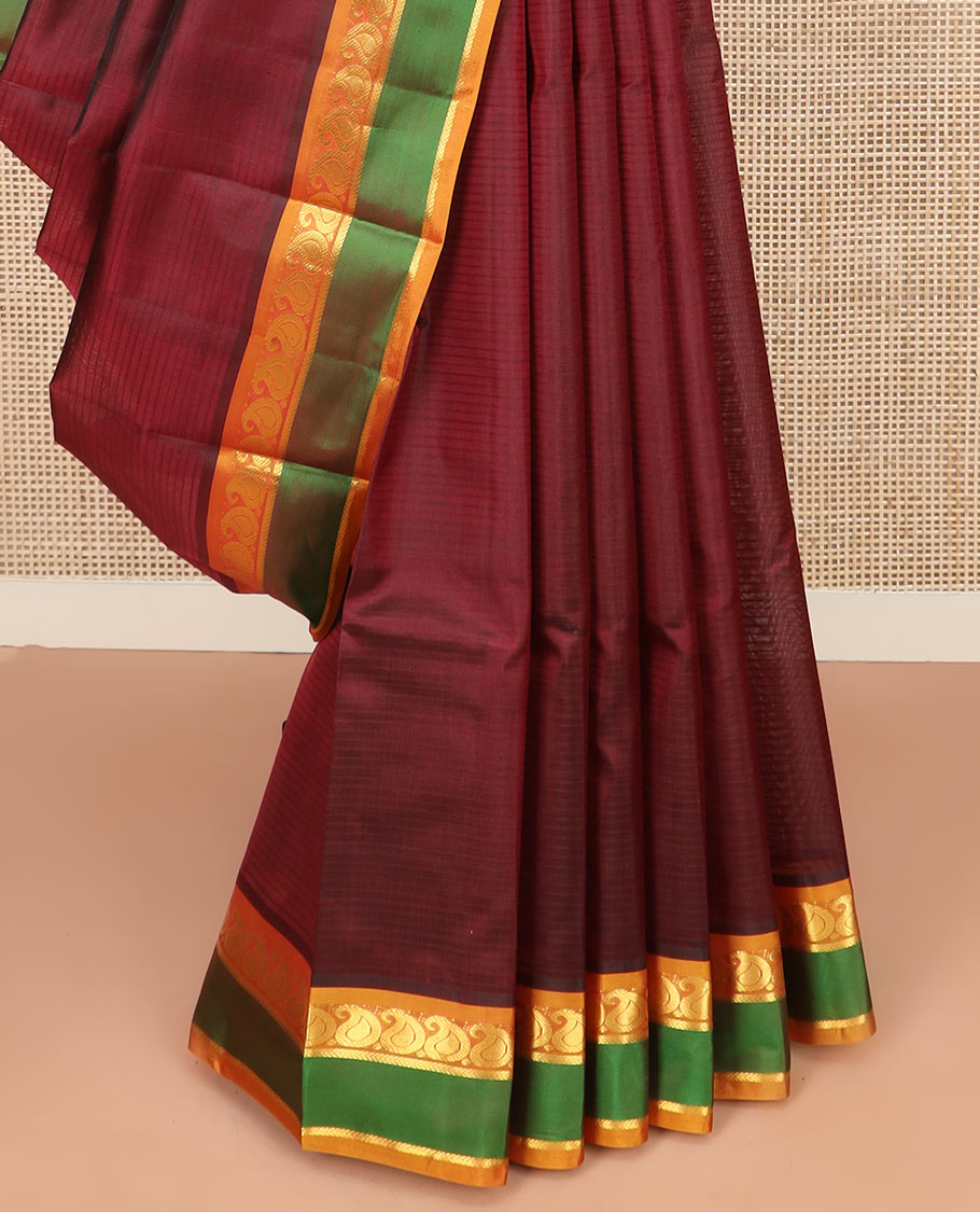Maroon Kanchipuram Silk Saree Depicting All-Over Stripes and Manga Buttas, Complemented with Contrast Manga and Kathir Design Rettai Pettu Border, Pallu of Zari Designs, and Paired with a Contrast Blouse