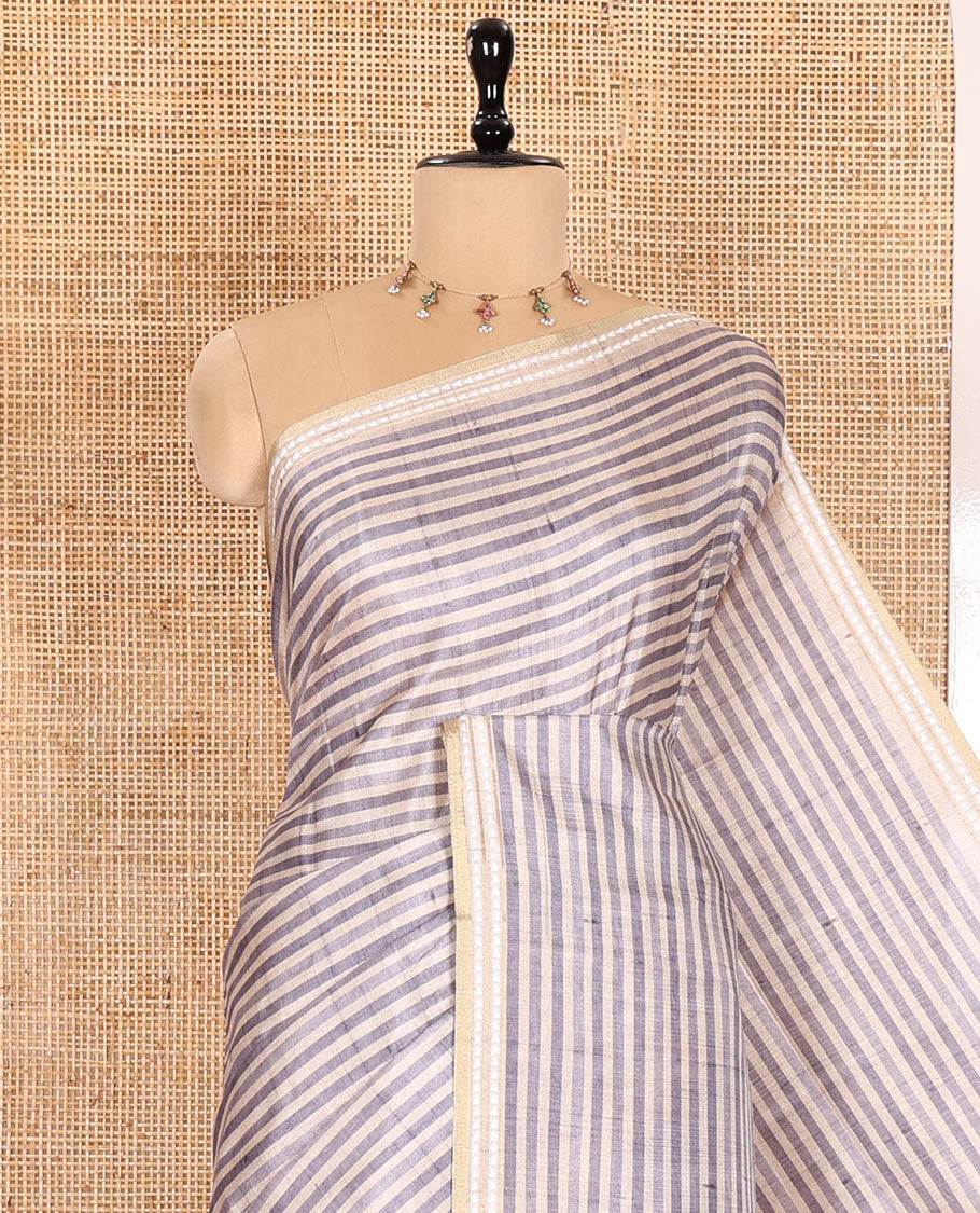 Grey Semi-Tussar Saree Featuring Horizontal Stripe Prints, Accentuated by a Subtle Resham Thread Temple-Designed Border, with a Pallu Highlighted by Intricate Circular Motifs, Paired with a Contrast Bandhani Blouse