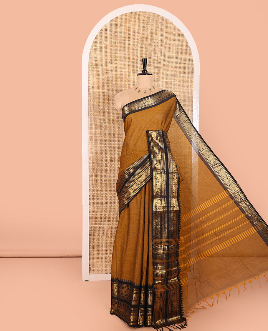 Mustard Plain Chettinad Cotton Saree, Complemented by a Contrast Temple Rettai Pettu Border Featuring Elephant, and Peacock Motifs, Subtly Striped Pallu, and Paired with a Matching Blouse