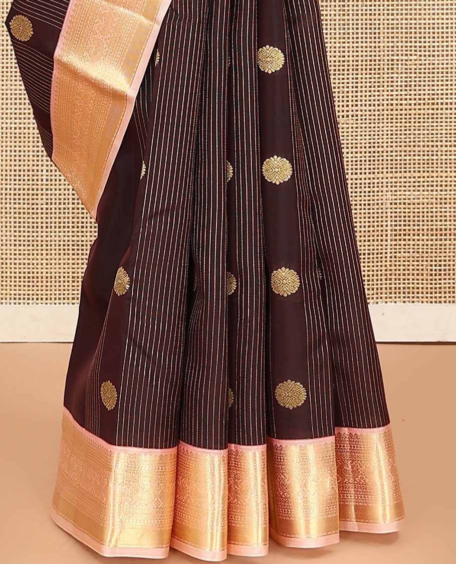 Brown Vasundhara Lite Silk Mix Saree, Prettified with Stripes, and Chakram Buttas, Complemented by a Contrast Border of Thilakam Mokku, Muthu, Banaras, Neli, and Mayil Designs, Pallu Steeped with Peacock Feather Designs, and Paired with a Contrast Blouse
