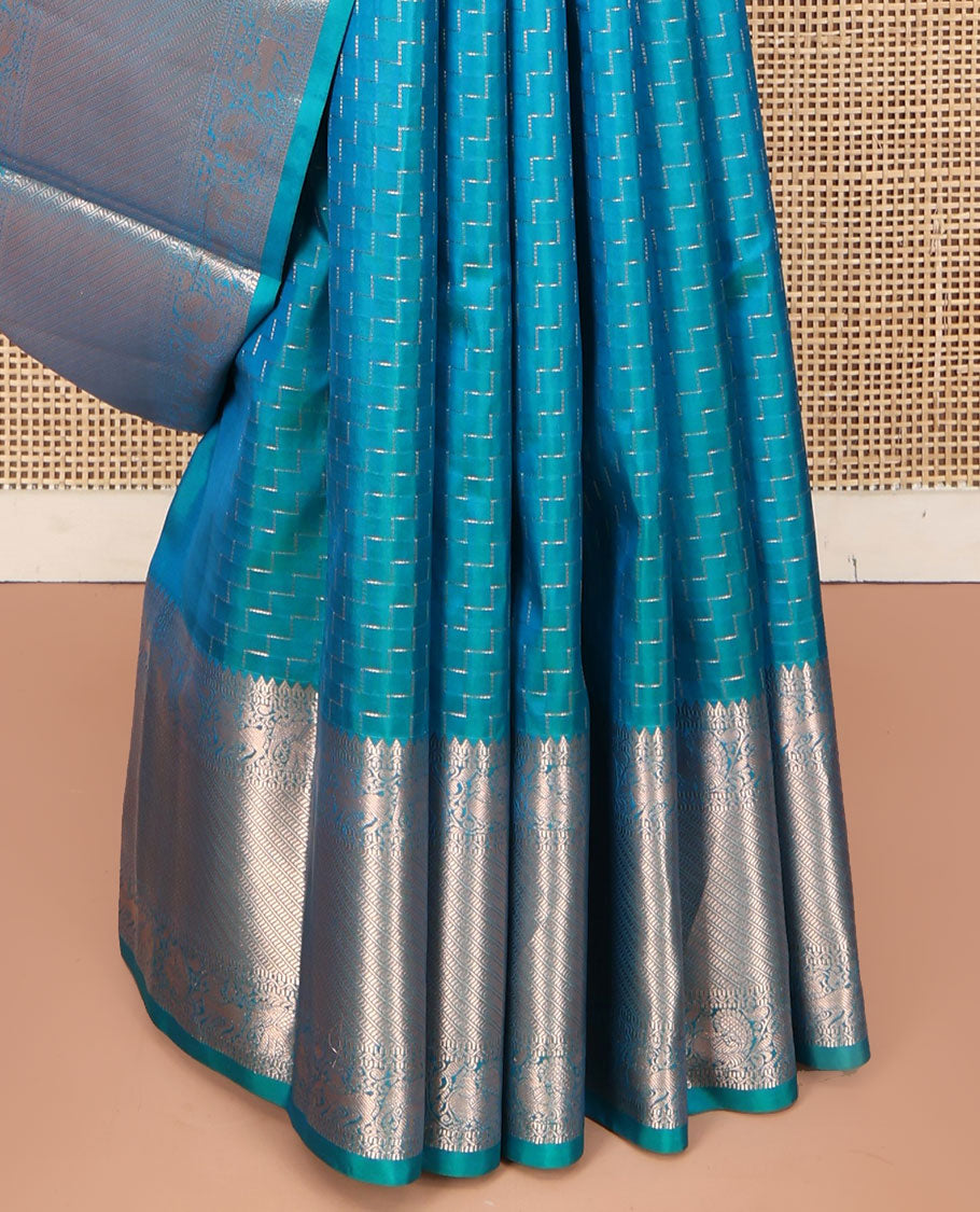 Blue Vasundhara Silk Saree, Beautifully Bedecked with Zig-Zag Stripes All Over Its Body, Highlighted by a Zari Border of Rekku, Muthu, Neli, Mayil, and Yaali Designs, Grand Jaal Pallu, and Paired with a Matching Blouse
