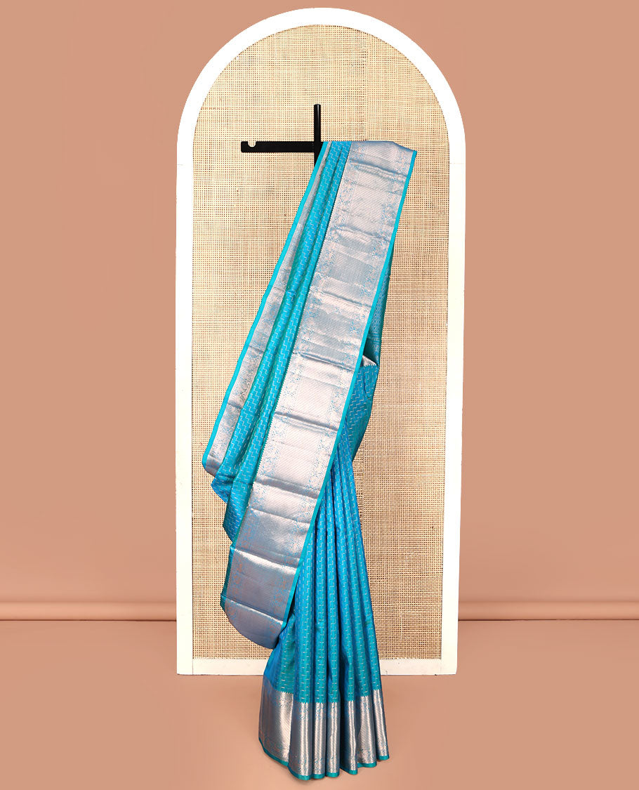 Blue Vasundhara Silk Saree, Beautifully Bedecked with Zig-Zag Stripes All Over Its Body, Highlighted by a Zari Border of Rekku, Muthu, Neli, Mayil, and Yaali Designs, Grand Jaal Pallu, and Paired with a Matching Blouse