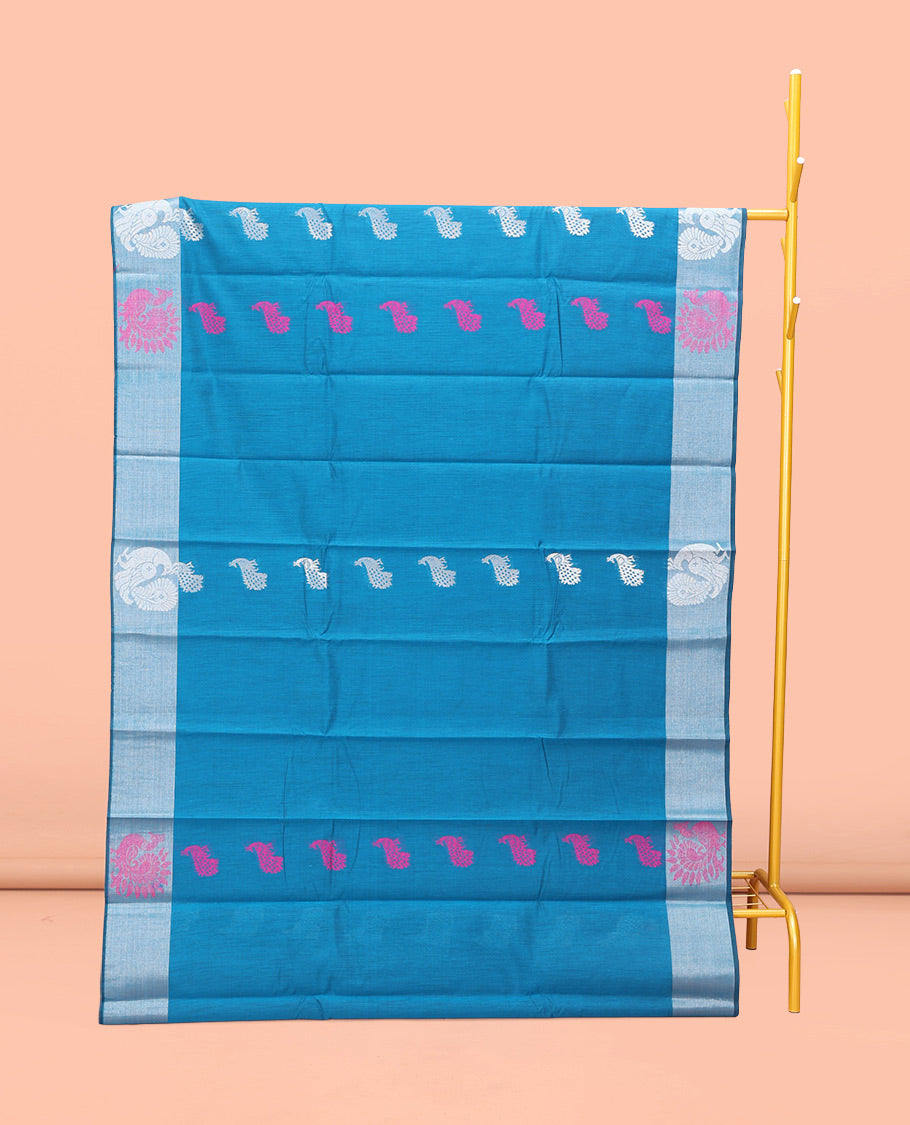 Blue Semi-Silk Cotton Saree, Uniquely Detailed with Peacock Buttas All Over Its Body, Highlighted by a Zari Border of Peacock Designs, Pallu Steeped with Peacock Zari Motifs, and Paired with a Matching Blouse